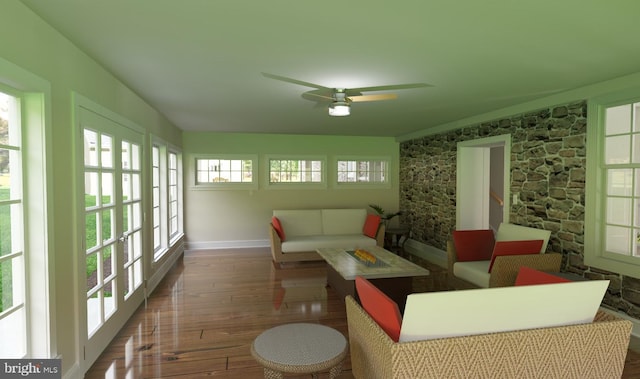 sunroom / solarium featuring ceiling fan