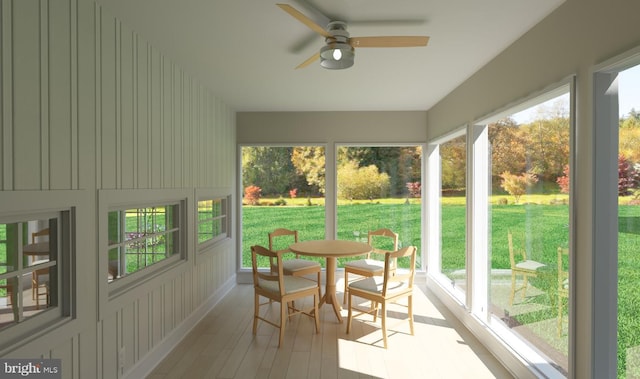 sunroom featuring ceiling fan