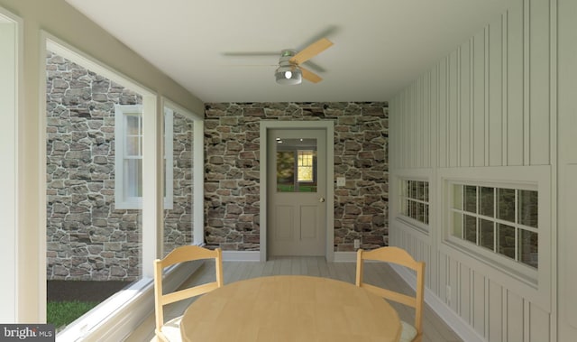 sunroom / solarium featuring ceiling fan