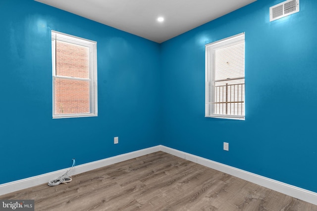 spare room featuring light hardwood / wood-style floors