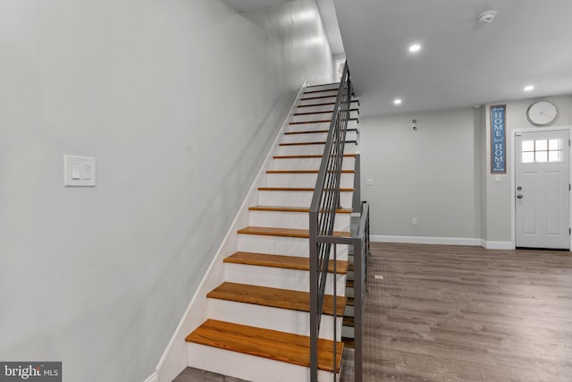 stairs with hardwood / wood-style flooring