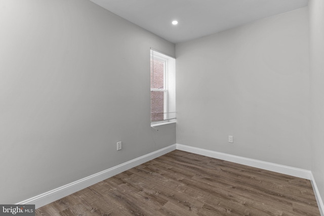 unfurnished room with wood-type flooring