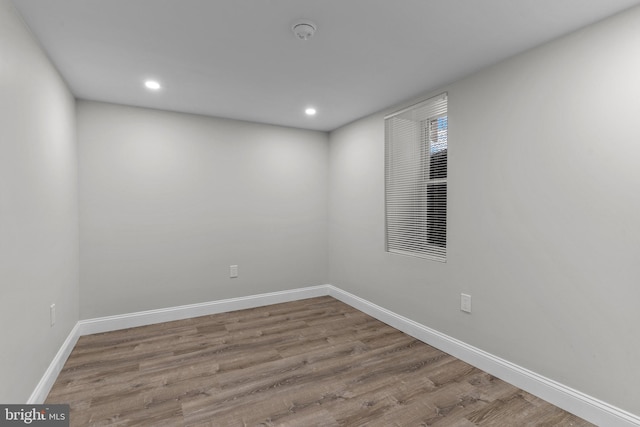 unfurnished room with hardwood / wood-style flooring