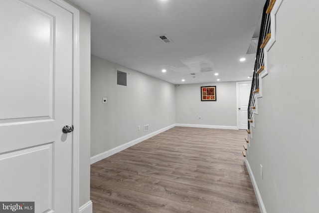 basement with light hardwood / wood-style flooring