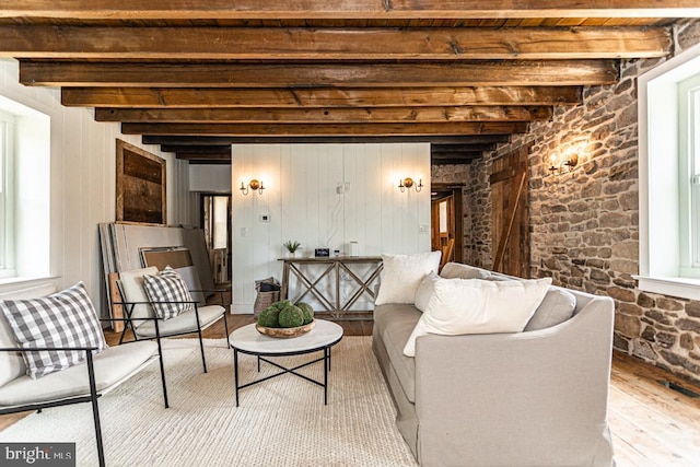 living room featuring beam ceiling and hardwood / wood-style floors