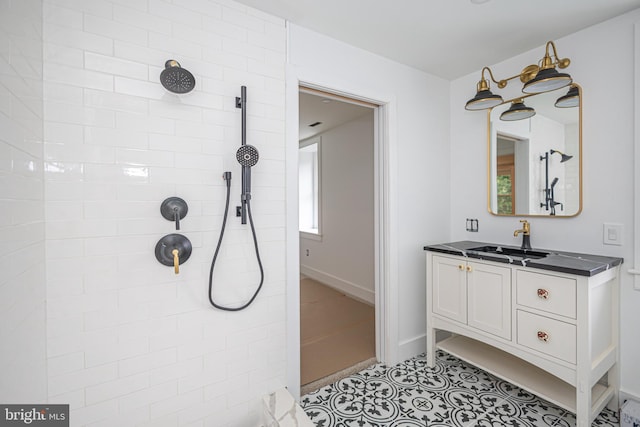 bathroom with vanity and a tile shower