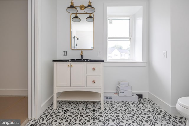 bathroom with vanity, toilet, and tile patterned flooring