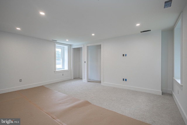 unfurnished room featuring light colored carpet