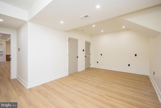 additional living space with light hardwood / wood-style floors