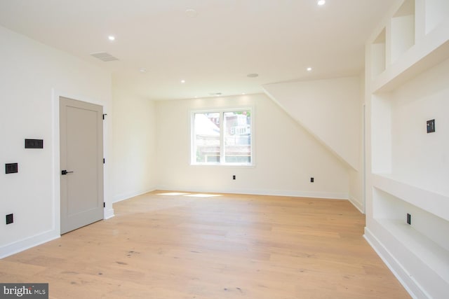 additional living space featuring light wood-type flooring