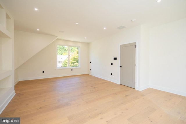 additional living space featuring light hardwood / wood-style floors