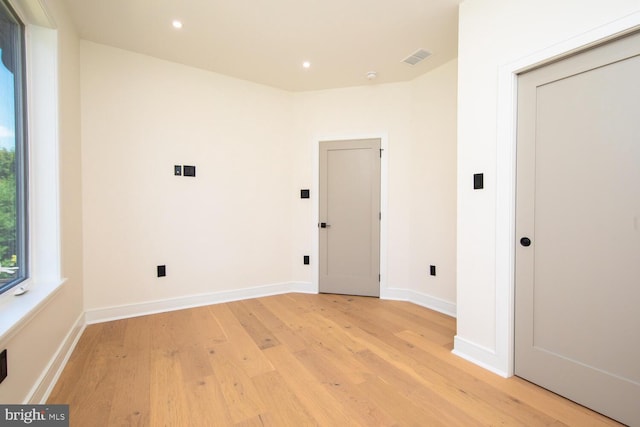 laundry room with light hardwood / wood-style floors