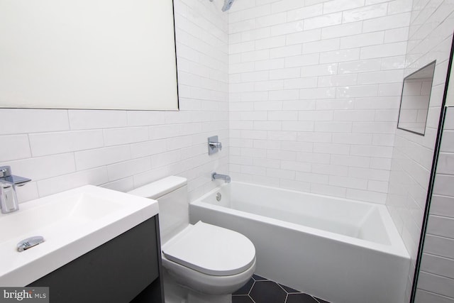 full bathroom with tile walls, tile patterned flooring, tiled shower / bath, and toilet