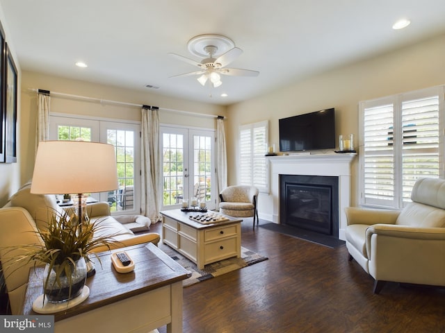 living room featuring ceiling fan, french doors, and dark hardwood / wood-style floors