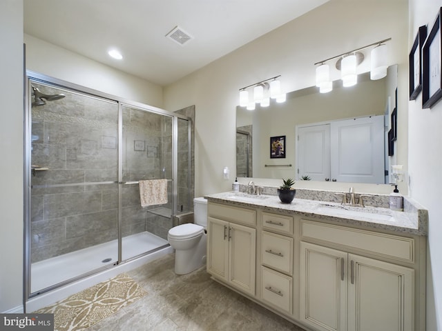 bathroom featuring tile patterned flooring, an enclosed shower, toilet, and vanity