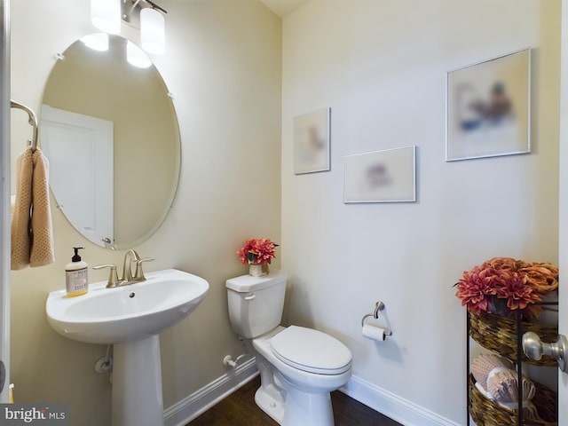 bathroom with wood-type flooring and toilet