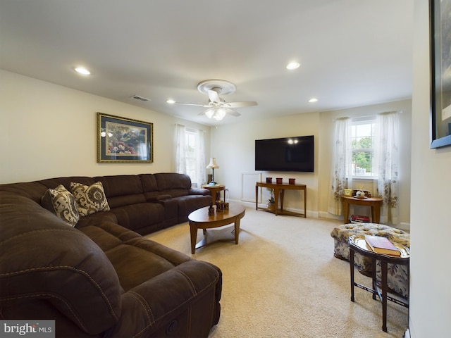 living room featuring ceiling fan and light carpet