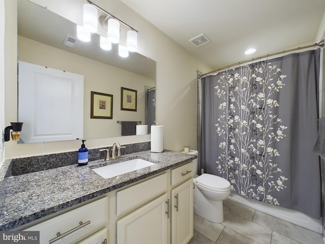 bathroom featuring tile patterned flooring, toilet, walk in shower, and vanity