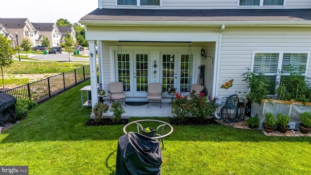 property entrance featuring french doors and a lawn