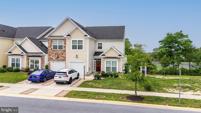 view of front of property with a garage and a front lawn