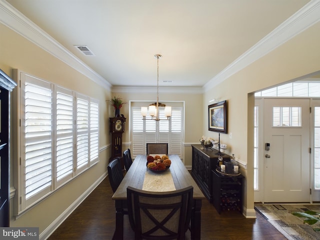 dining space featuring a notable chandelier, dark wood-type flooring, and ornamental molding