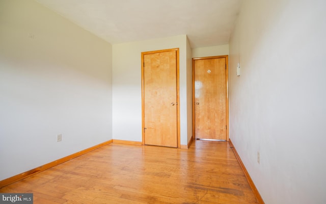 empty room with light hardwood / wood-style flooring