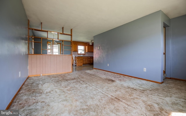 unfurnished living room featuring light colored carpet