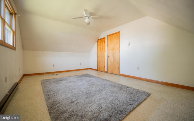 bonus room featuring ceiling fan, lofted ceiling, and a baseboard heating unit