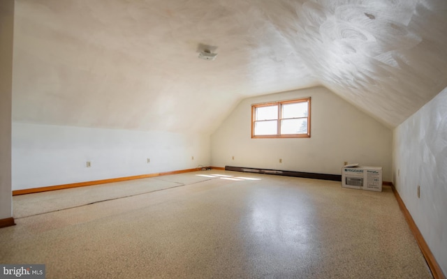 additional living space featuring vaulted ceiling