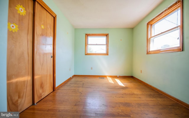 unfurnished bedroom featuring a closet and light wood-type flooring