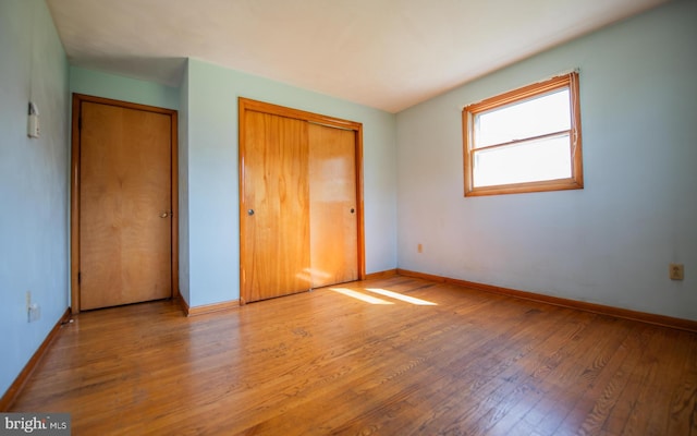 unfurnished bedroom with hardwood / wood-style floors