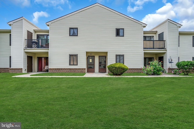 rear view of property with a lawn