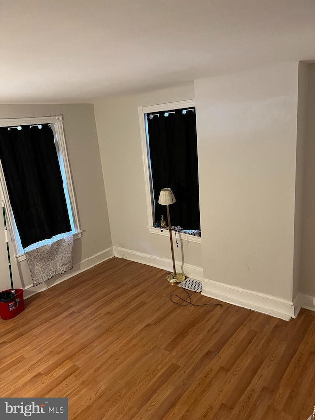 empty room with hardwood / wood-style floors