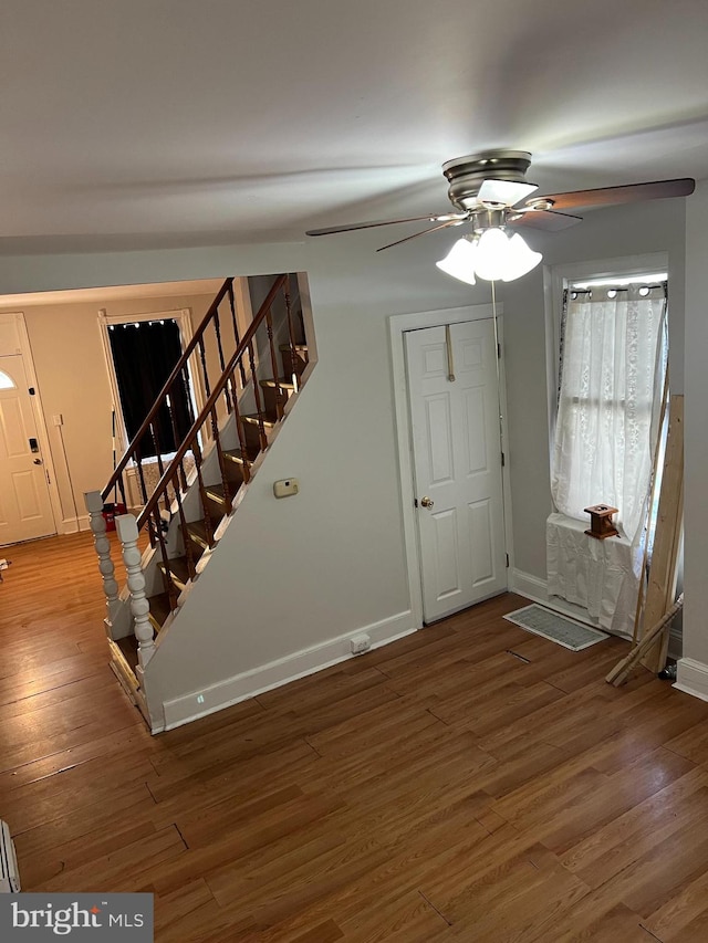 foyer with hardwood / wood-style flooring and ceiling fan