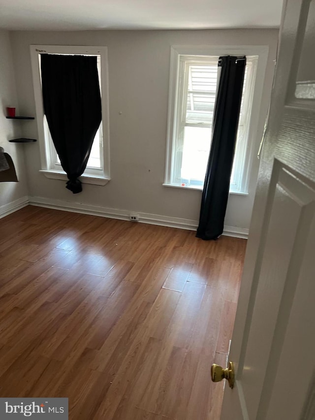 spare room with light hardwood / wood-style flooring