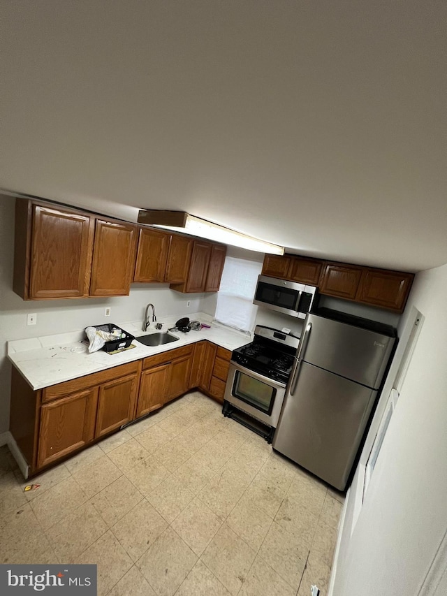 kitchen with sink, appliances with stainless steel finishes, and light tile patterned floors