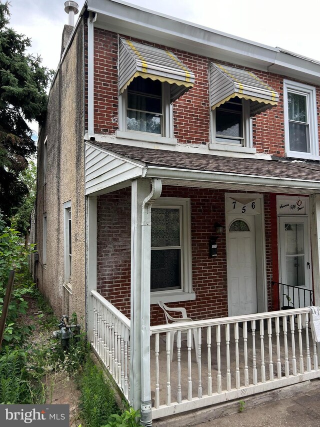 view of exterior entry with covered porch