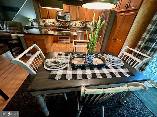 dining space featuring wood-type flooring