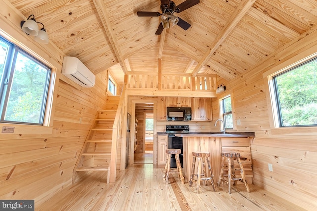 kitchen with wooden walls, wood ceiling, an AC wall unit, light wood-type flooring, and black microwave