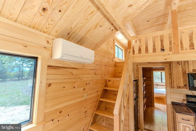 stairway with an AC wall unit, wooden ceiling, wooden walls, and wood finished floors