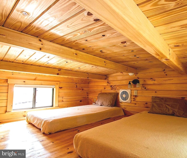 unfurnished bedroom with wood walls, beamed ceiling, wooden ceiling, and wood finished floors