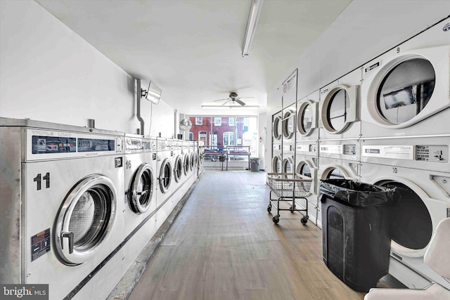 laundry area featuring separate washer and dryer, hardwood / wood-style floors, ceiling fan, and stacked washing maching and dryer