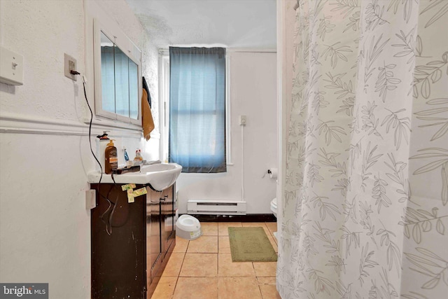 bathroom featuring vanity, tile patterned floors, toilet, and baseboard heating