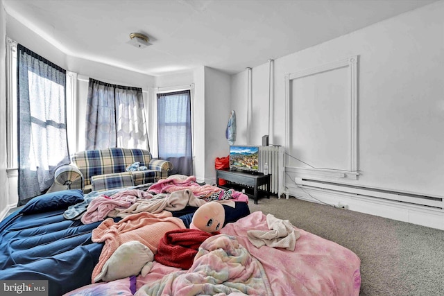 bedroom with multiple windows, carpet floors, a baseboard heating unit, and radiator heating unit