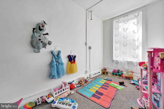 game room with carpet floors, a wealth of natural light, and baseboard heating