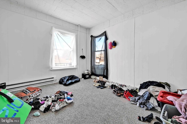 miscellaneous room featuring carpet flooring and a baseboard heating unit