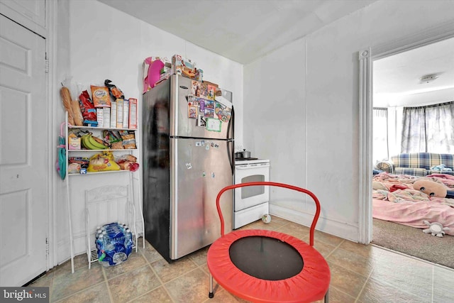 kitchen with stainless steel fridge and electric range