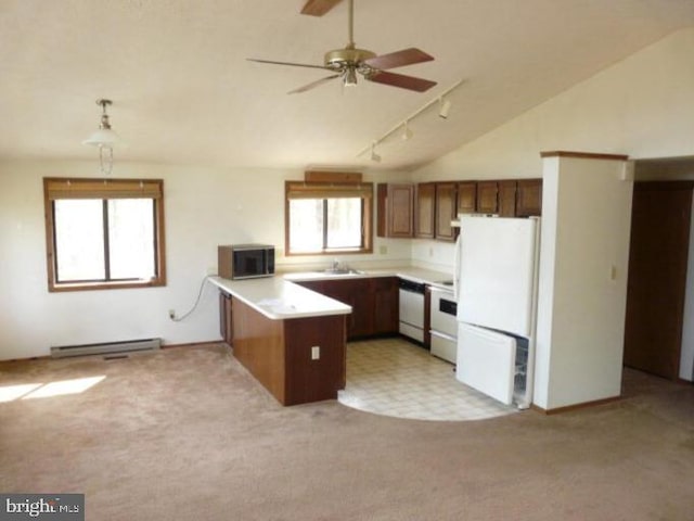 kitchen featuring sink, a baseboard radiator, kitchen peninsula, lofted ceiling, and white appliances