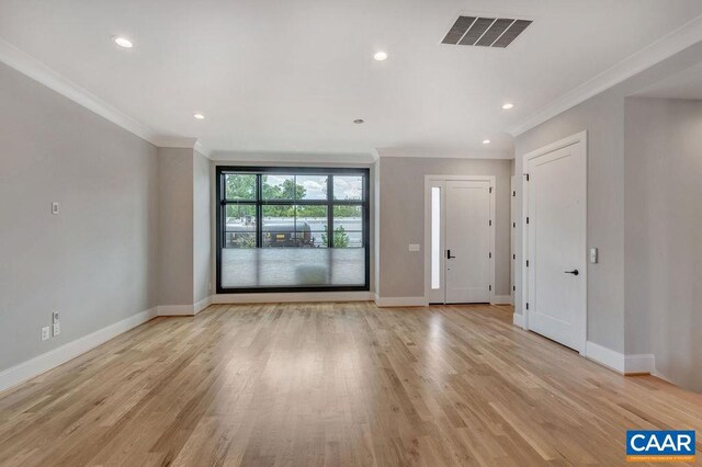 spare room with light hardwood / wood-style flooring and ornamental molding