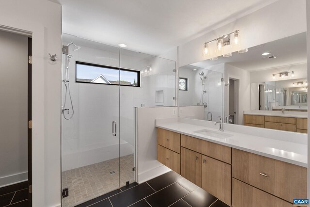 bathroom featuring tile patterned flooring, vanity, and an enclosed shower